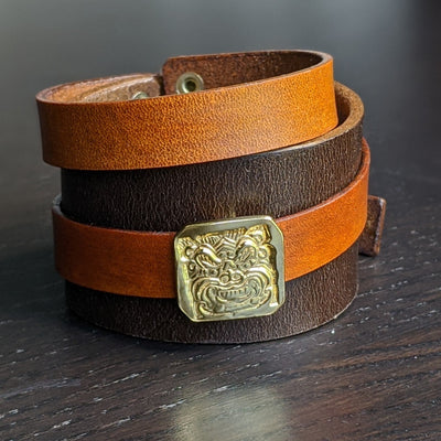 LEATHER BRACELET WITH GOLDEN DRAGON AMULET | < Z-FIRE.COM > .999 Fine Silver Amulet Removable 24K Gold Plated 1.5" Brown leather bracelet, with a 0.6" tan wrap-around leather strap About 1.5 Inches Total Length About 14 cm Total Length﻿ Free Astrology Report of Choice Free Standard Shipping Hassle Free Returns