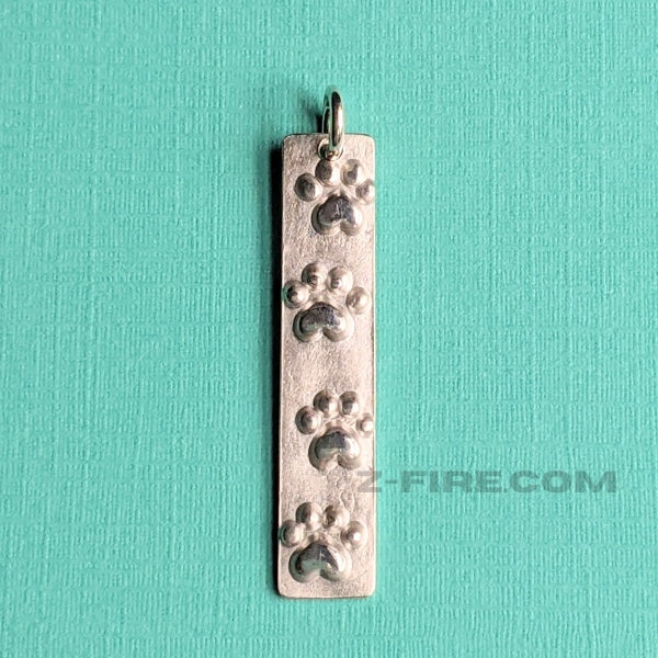 4 PAW - PRINTS CHARM | < Z-FIRE.COM > Cute .950 silver purity,  paw-print charm, to keep you company when away from your pet/s. .950 Silver Paw-Print Charm About 1 . 1/4" Inches in Total Length About 3 cm Total Length 1/4" Inches Wide 6 mm Wide Add a hand written Name or Text onto the back