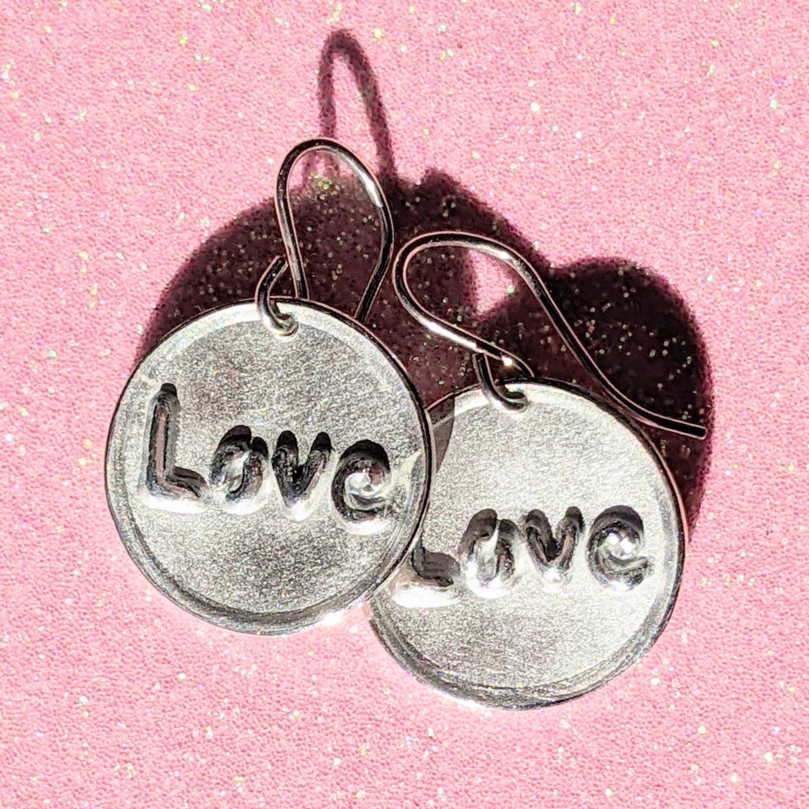 ROUND LOVE EARRINGS | <Z-FIRE.COM> The text "Love" is polished and highlighted on a frosted round background with polished edges.  .950 Fine Silver Discs About 11/16" Diameter About 1.8 cm Diameter .925 Sterling Silver Ear Wires