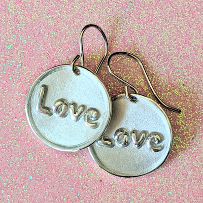 ROUND LOVE EARRINGS | <Z-FIRE.COM> The text "Love" is polished and highlighted on a frosted round background with polished edges.  .950 Fine Silver Discs About 11/16" Diameter About 1.8 cm Diameter .925 Sterling Silver Ear Wires