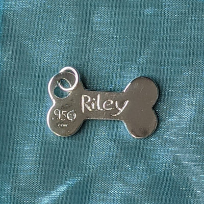 DOG BONE CHARM / LARGE | < Z-FIRE.COM > Cute dog bone charm to keep you feeling connected when away from your pet. .950 Silver Dog Bone Charm About 10/16" Inches Wide About 16 mm Wide To add a name onto the back of the charm, use the seller's instruction box at checkout. Free Astrological Report of Choice Free standard shipping Hassle-Free Returns
