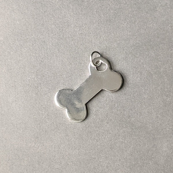 DOG BONE CHARM / LARGE | < Z-FIRE.COM > Cute dog bone charm to keep you feeling connected when away from your pet. .950 Silver Dog Bone Charm About 10/16" Inches Wide About 16 mm Wide To add a name onto the back of the charm, use the seller's instruction box at checkout. Free Astrological Report of Choice Free standard shipping Hassle-Free Returns