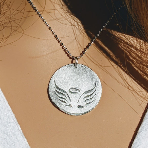 FROSTED ANGEL WINGS PENDANT | <Z-FIRE.COM> Made to Order Add a Name on the back .999 Fine Silver Angel Wings Pendant .925 Sterling Silver Jump Ring 1" Diameter  Chain Specifications: Metal type: Sterling Silver Karat/purity: 925 Width : 1.5mm Overall Length/Dimensions : 24" (adjustable) Clasp Type: Spring Ring Style: Bead Metal color: White