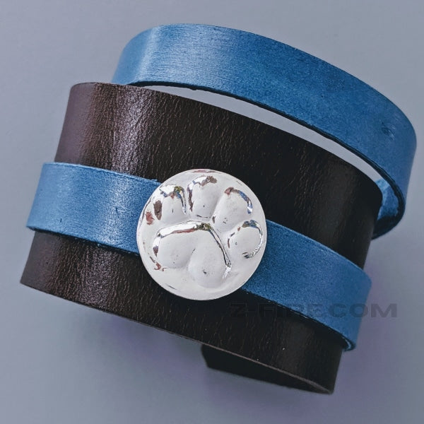 LEATHER BRACELET WITH REMOVABLE PAW-PRINT AMULET | < Z-FIRE.COM > Leather Bracelet about 1 and 6/8" wide Leather Bracelet about 4.5 cm wide Removable .999 Fine Silver Silver Amulet 1.5" Dark Brown Leather Bracelet, with a 0.6" denim wrap-around leather strap 4.5 cm Black Leather Bracelet, with a 1.5 cm denim wrap-around leather strap Free Astrological Report of choice Free standard shipping Hassle Free Returns
