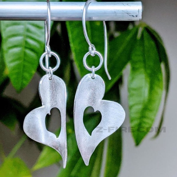  MELTED HEART CHAKRA EARRINGS | <Z-FIRE.COM> .999 Fine Silver Hearts .925 Sterling Silver Wires 0.5" Wide 1cm Wide 2.25" Total Length 5.75 cm Total Length Free Astrological Report of Choice Free Standard Shipping Hassle Free Returns Each piece is handcrafted and will differ slightly from piece to piece and will sometimes need a lead time of up to a week.